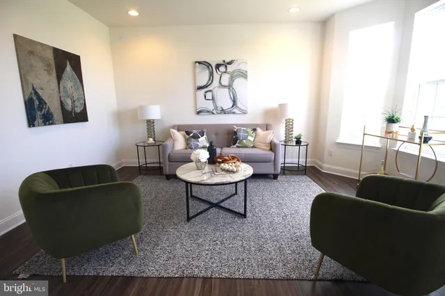 a living room with furniture and a potted plant