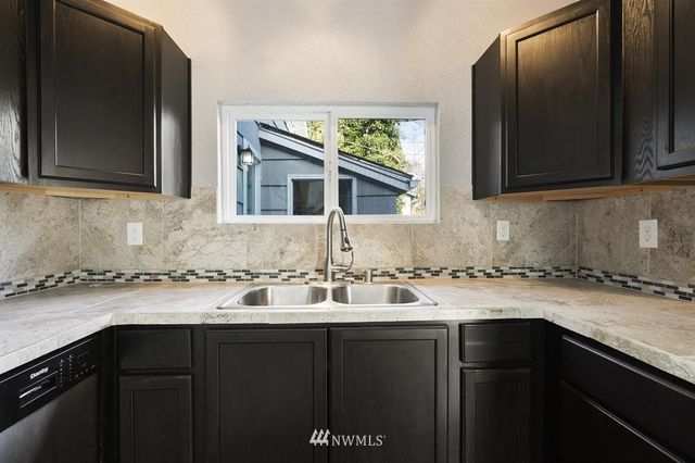 a kitchen with a sink and a microwave