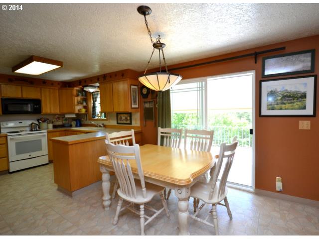 22871 South Reid Road Estacada, OR 97023 - Photo 5 of 16 a dining room with furniture a chandelier and kitchen view