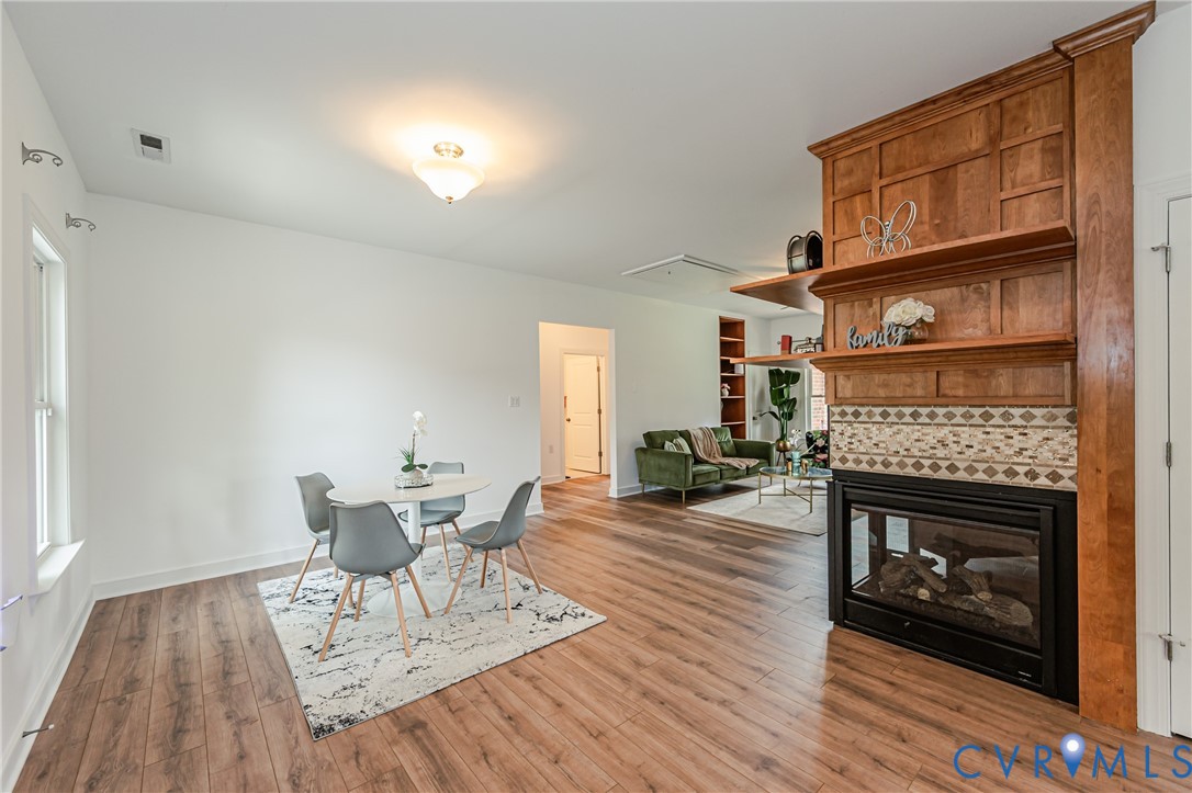 2018 Valentine Road Henrico, VA 23228 - Photo 22 of 65 a living room with furniture a fireplace and a wooden floor