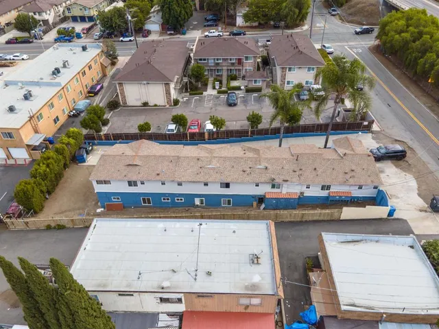 an aerial view of a house with a yard and lake view