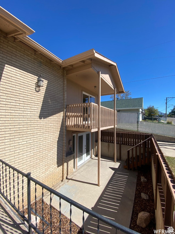 2182 West 5600th Street South Roy, UT 84067 - Photo 11 of 11 Brick exterior with a second-story balcony featuring wood railings