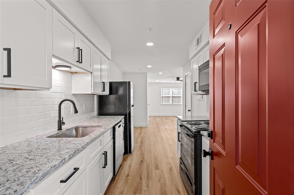 125 13th Street Southeast, Unit 201 Paris, TX 75460 - Photo 1 of 11 a kitchen with stainless steel appliances granite countertop a sink stove and refrigerator