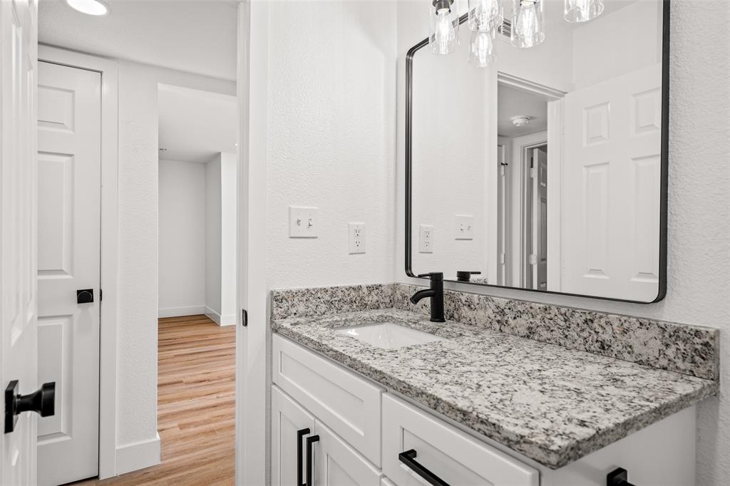 125 13th Street Southeast, Unit 201 Paris, TX 75460 - Photo 7 of 11 a bathroom with a sink and a mirror