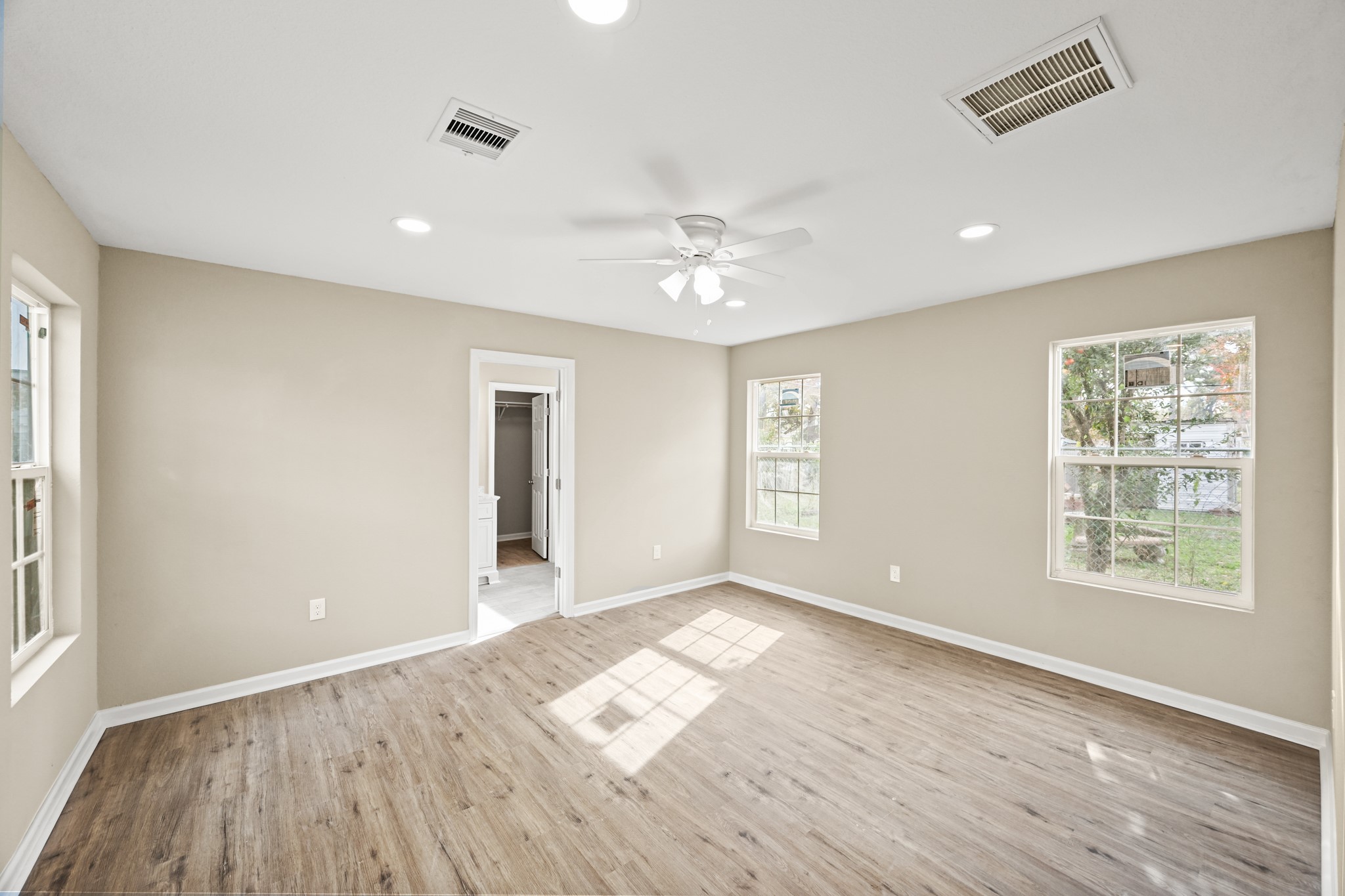 1007 Gazin Street Houston, TX 77020 - Photo 17 of 29 an empty room with wooden floor and windows