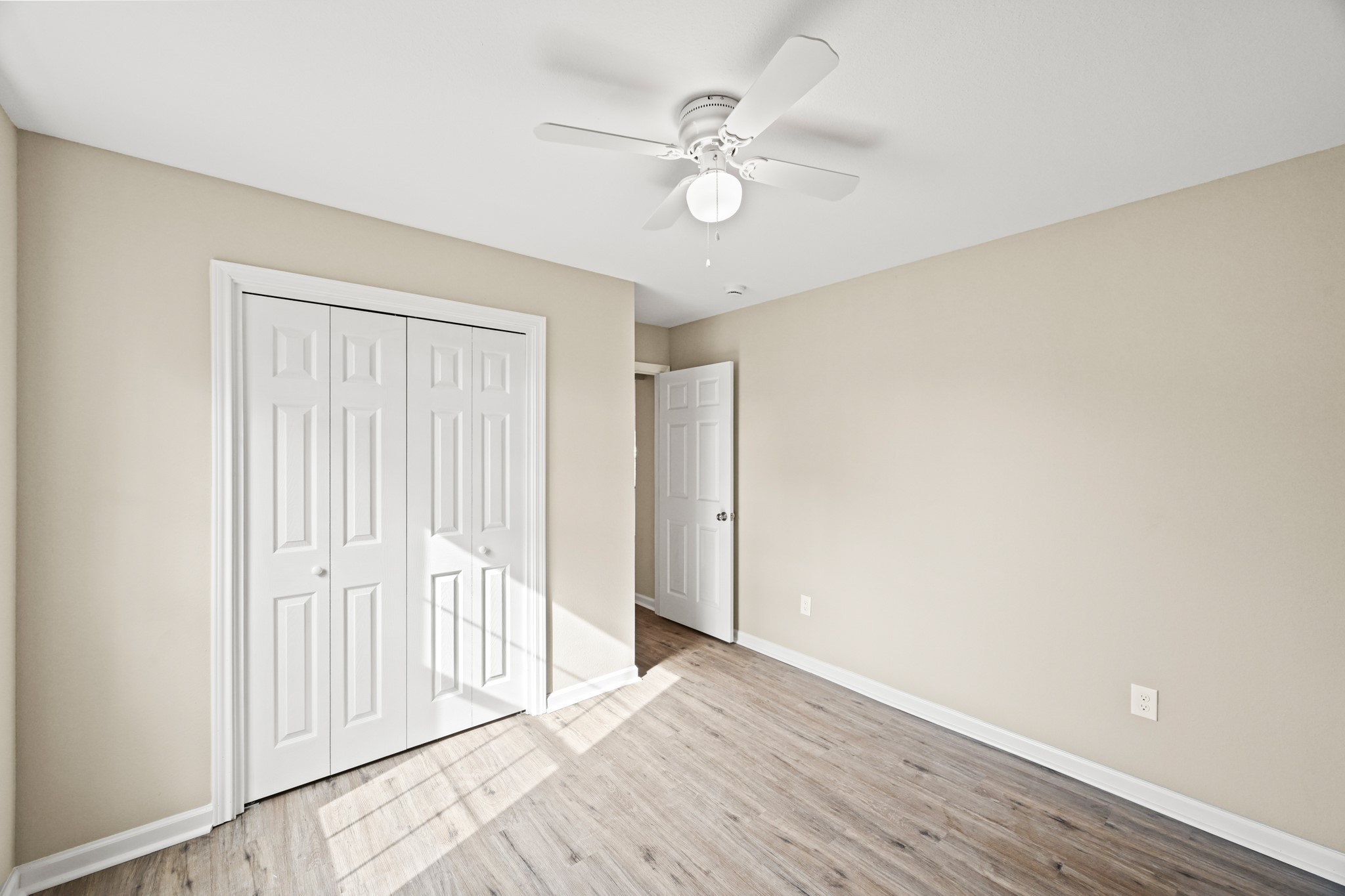 1007 Gazin Street Houston, TX 77020 - Photo 20 of 29 an empty room with wooden floor and fan
