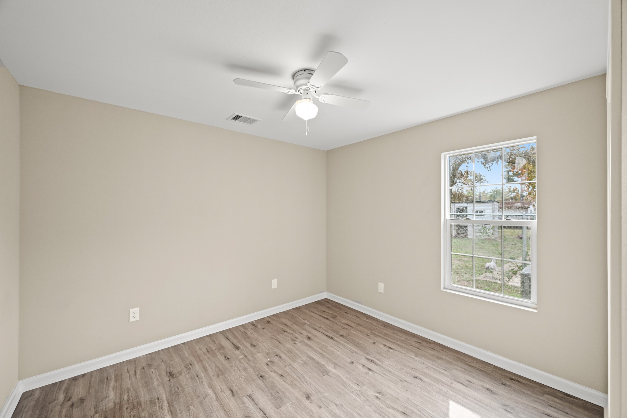 1007 Gazin Street Houston, TX 77020 - Photo 21 of 29 wooden floor in an empty room with a window