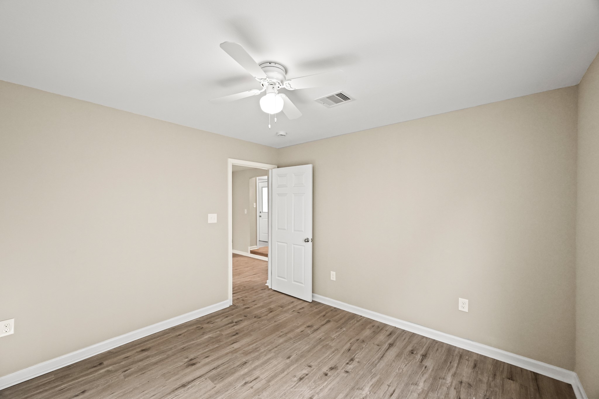 1007 Gazin Street Houston, TX 77020 - Photo 22 of 29 an empty room with wooden floor and fan