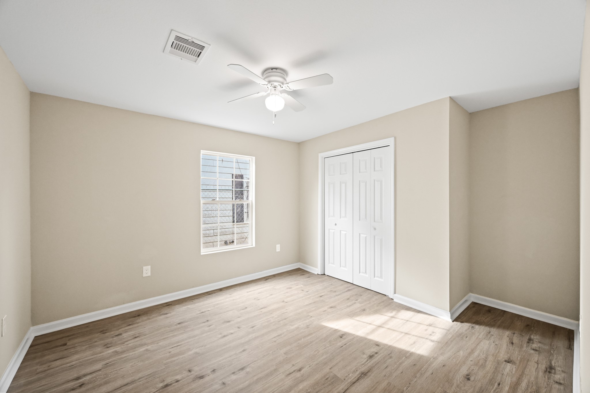 1007 Gazin Street Houston, TX 77020 - Photo 23 of 29 a view of an empty room with wooden floor and a window