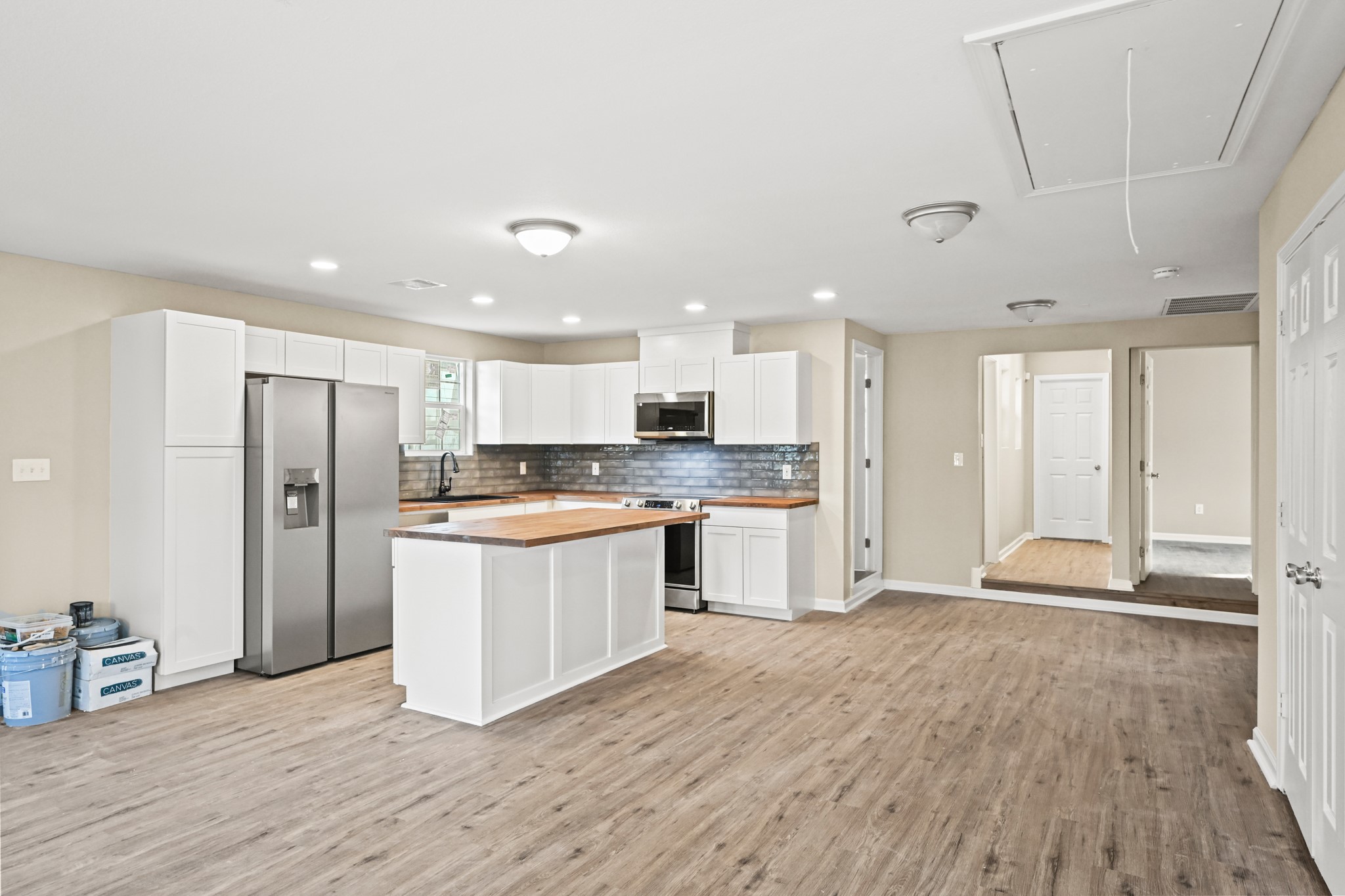 1007 Gazin Street Houston, TX 77020 - Photo 3 of 29 a large kitchen with stainless steel appliances kitchen island granite countertop a refrigerator and a sink