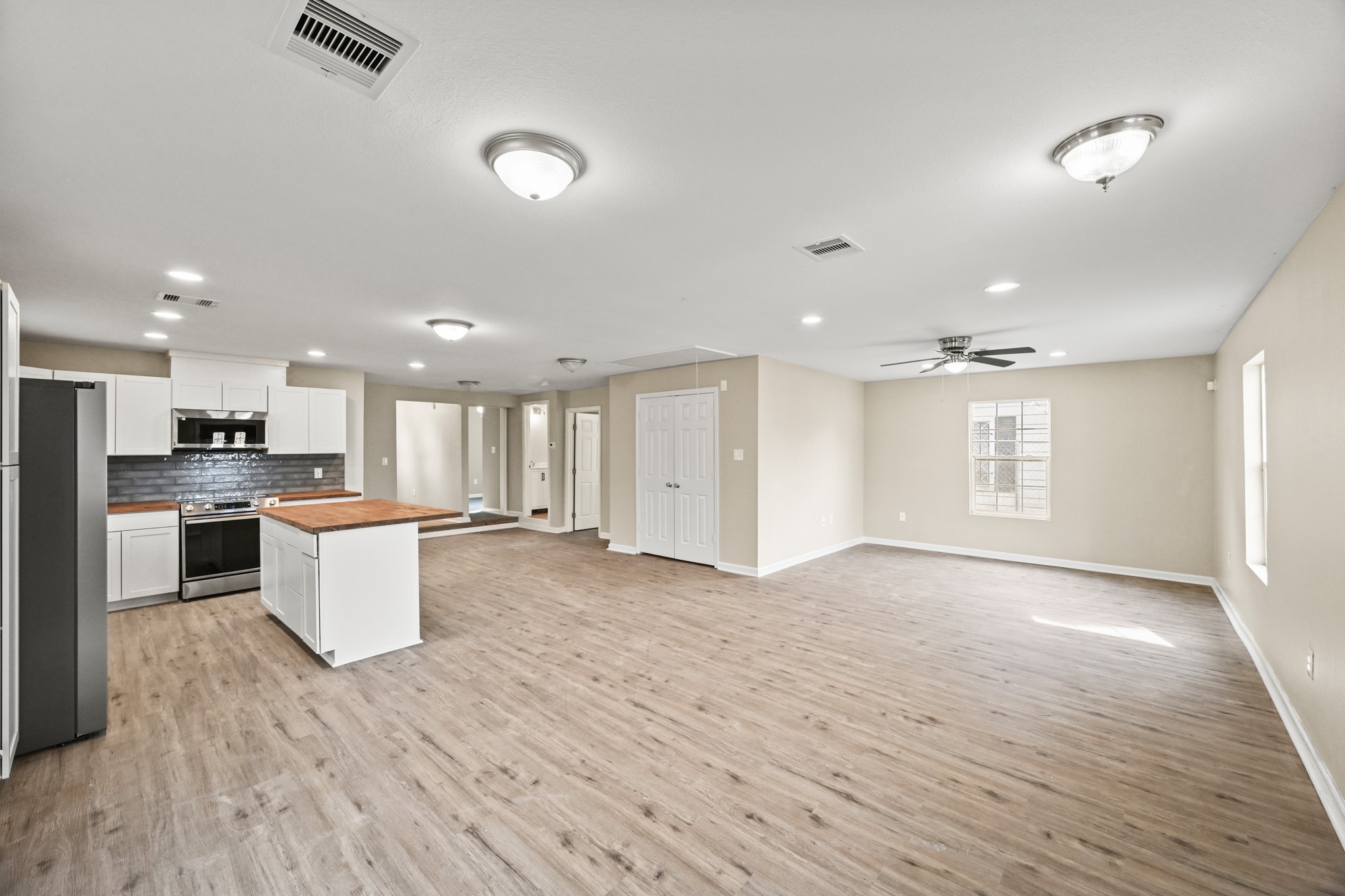 1007 Gazin Street Houston, TX 77020 - Photo 5 of 29 a view of kitchen with kitchen island wooden floor center island and stainless steel appliances