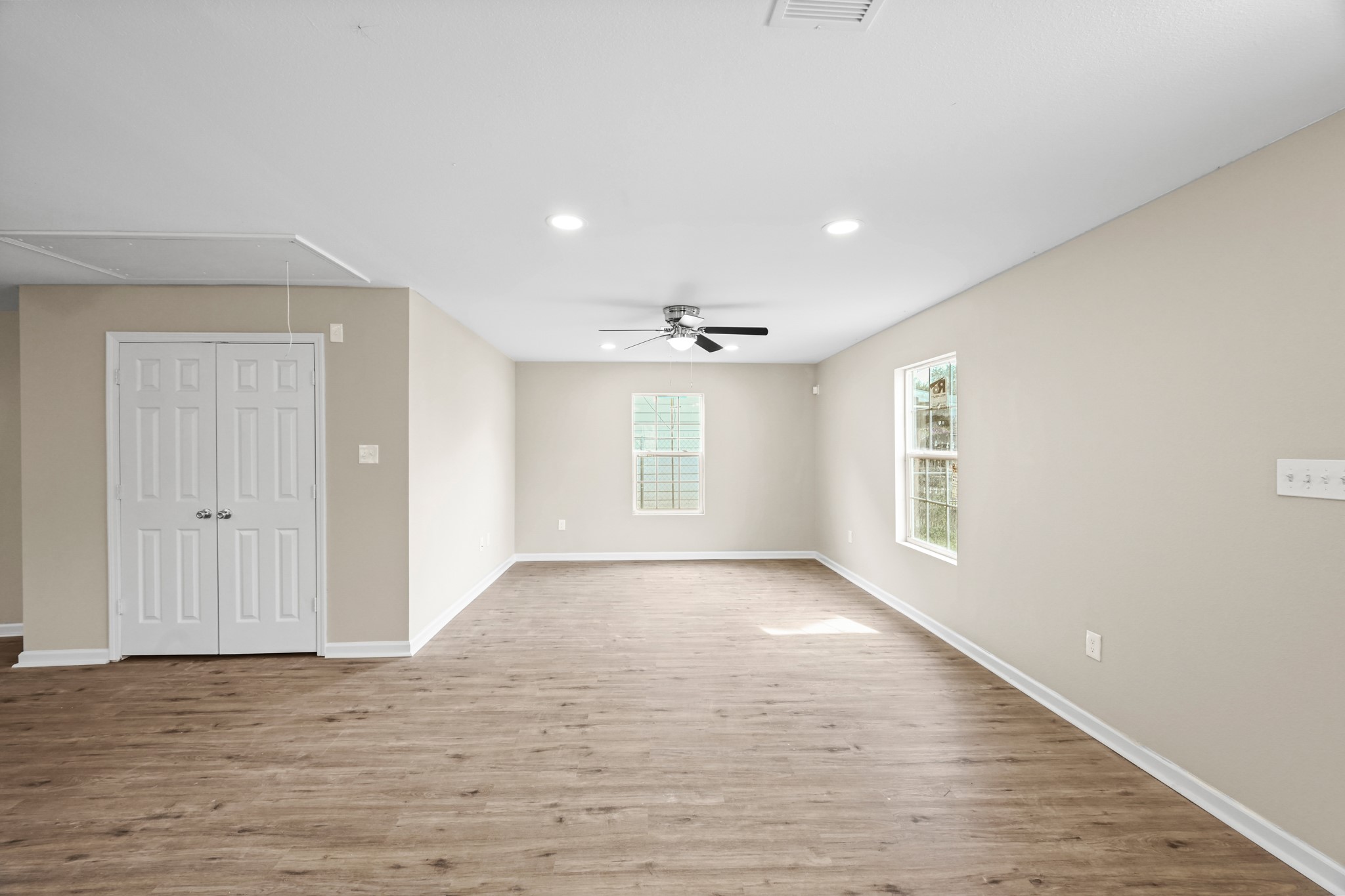 1007 Gazin Street Houston, TX 77020 - Photo 8 of 29 a view of an empty room with wooden floor and a window