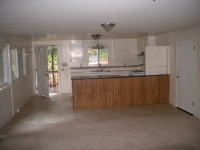 44 Ridge Way Mount Hermon, CA 95041 - Photo 4 of 12 a kitchen with stainless steel appliances granite countertop a refrigerator a sink and dishwasher