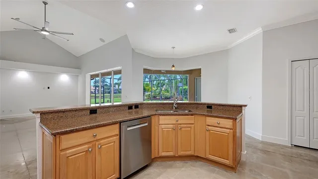 a kitchen with stainless steel appliances granite countertop a refrigerator and a stove