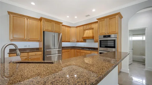 a view of a kitchen with a refrigerator and a sink