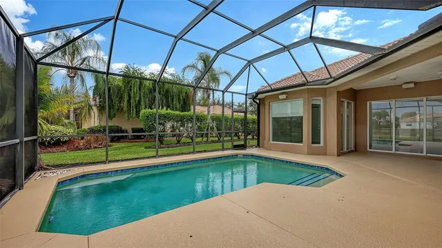 a view of a house with swimming pool and a yard