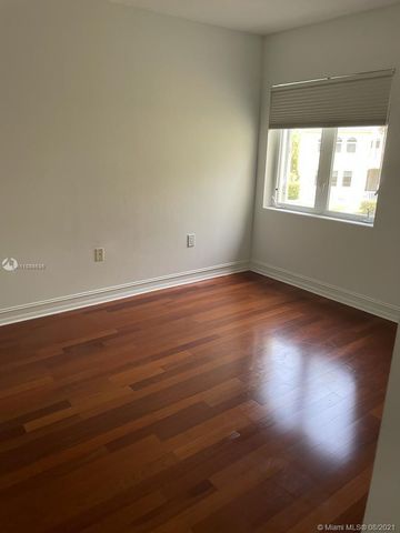 a large white tub sitting in a bathroom next to a window