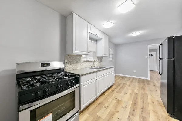 a kitchen with a stove a refrigerator and a sink