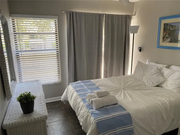 a bedroom with a bed and a window
