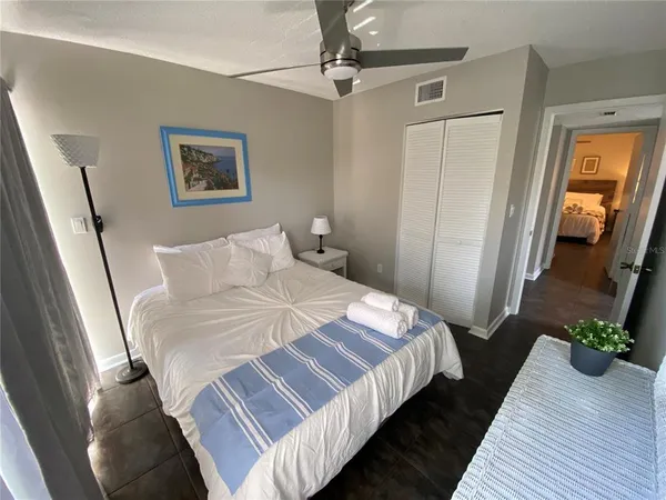 a bedroom with bed and a mirror