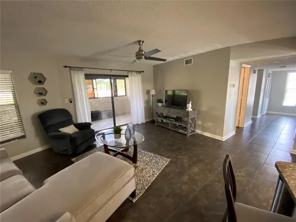 a living room with furniture gym equipment and a window