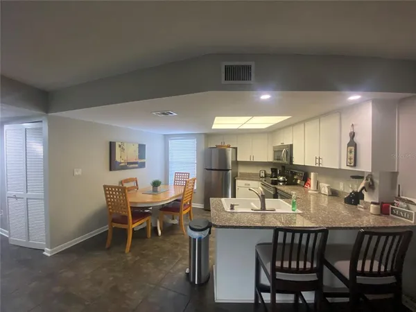 a dining room with a wooden table and chairs