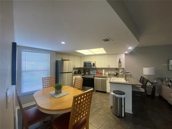 a kitchen with a table and chairs in it