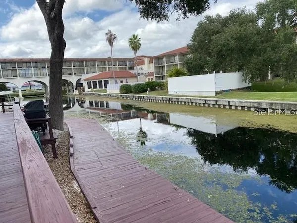 a view of a house with yard and sitting area