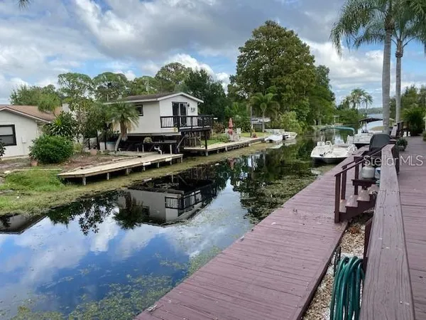 a view of a house with backyard outdoor seating area and barbeque oven