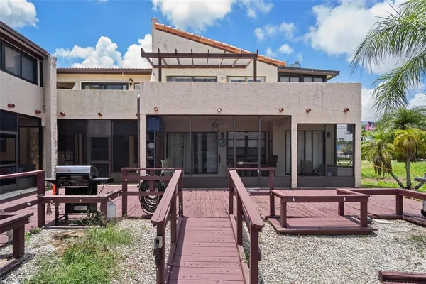 a view of a house with backyard porch and sitting area