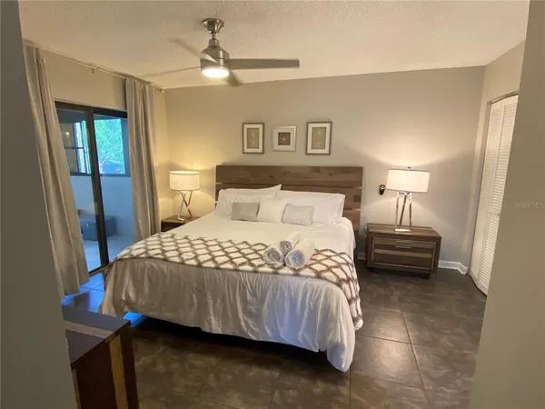 a bedroom with a bed and a lamp