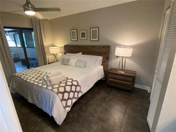 a bedroom with a bed and a lamp on table