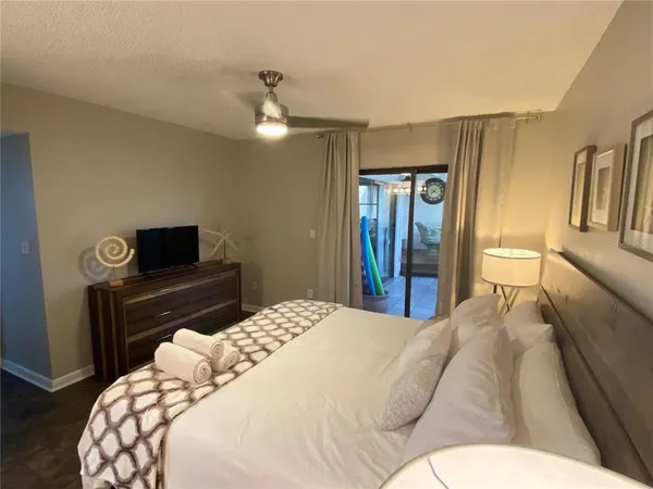 a bedroom with a bed and a television