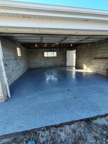 a kitchen with a sink and wooden floor