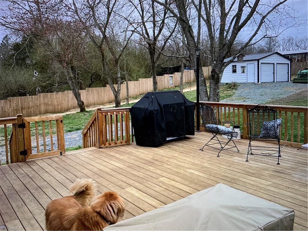 7741 Cedar Square Road Randleman, NC 27317 - Photo 5 of 18 Large new deck to enjoy the beautiful outdoors. Large 2 garage door building in the back corner of the yard.
