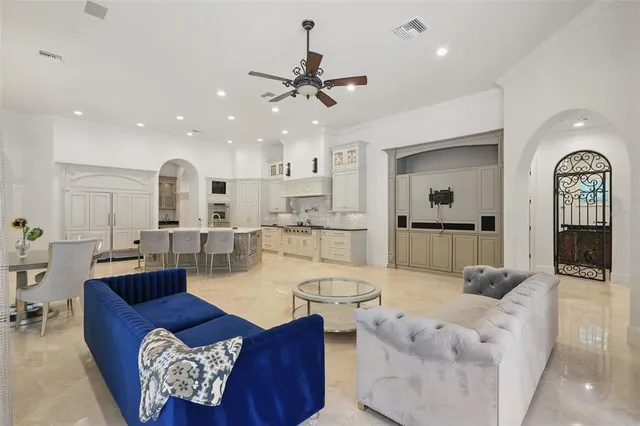 a living room with furniture a large window and a flat screen tv