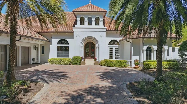 a front view of a house with yard and tress