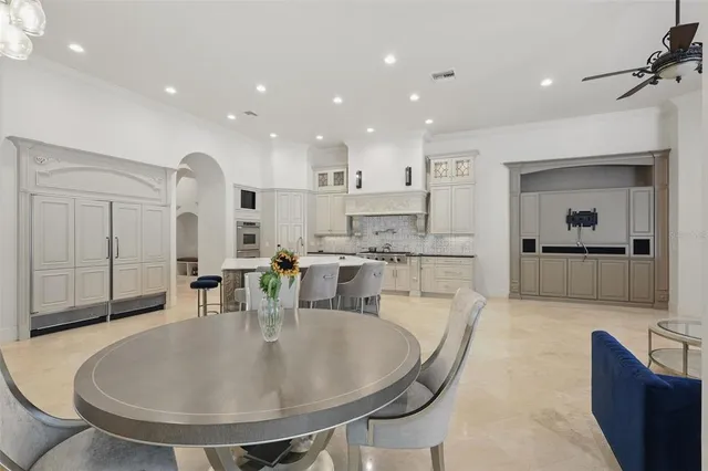 a kitchen with granite countertop white cabinets and chairs