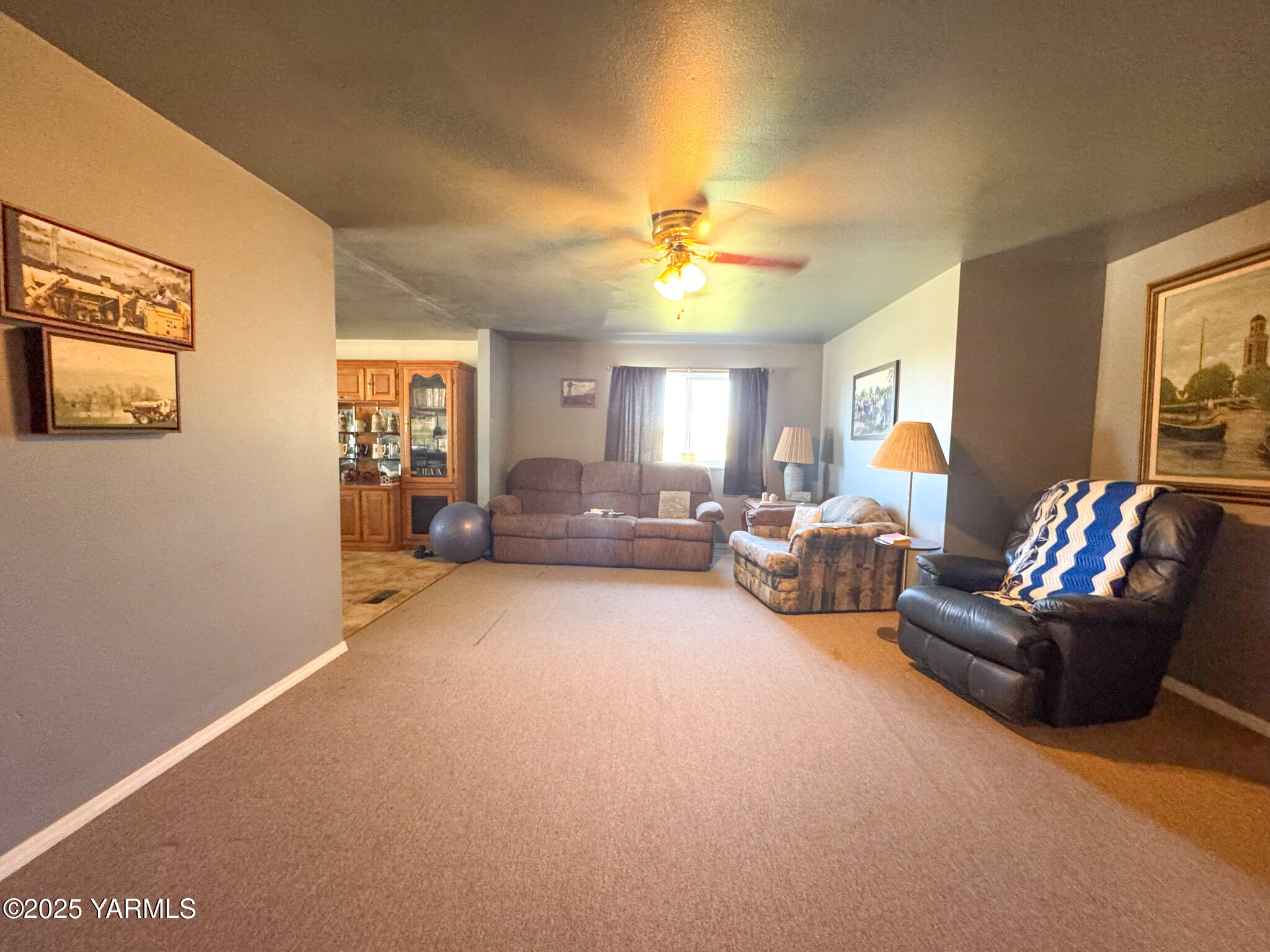 3321 Bethany Road Sunnyside, WA 98944 - Photo 11 of 24 a living room with furniture and a chandelier