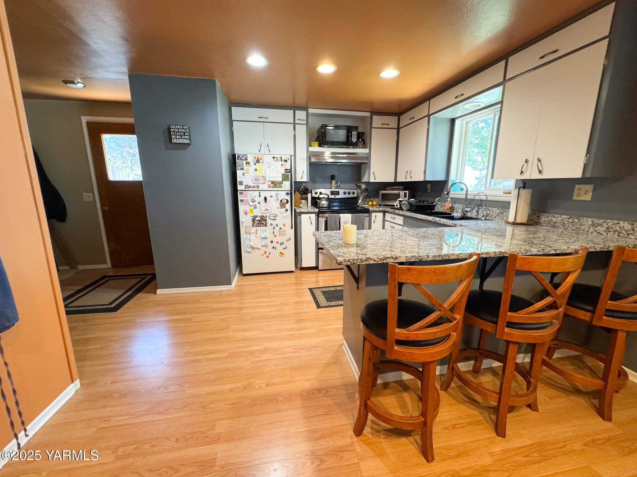 3321 Bethany Road Sunnyside, WA 98944 - Photo 10 of 24 a kitchen with granite countertop dining room cabinets and stainless steel appliances