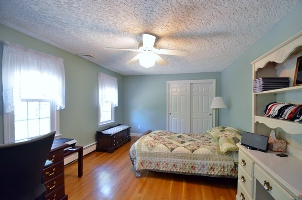 57 Green Road Bolton, MA 01740 - Photo 13 of 28 a bedroom with a bed and a chandelier