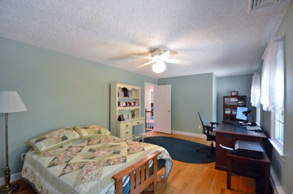 57 Green Road Bolton, MA 01740 - Photo 14 of 28 a bedroom with a bed and a chandelier