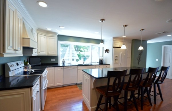 57 Green Road Bolton, MA 01740 - Photo 3 of 28 a kitchen with a table chairs stove and cabinets