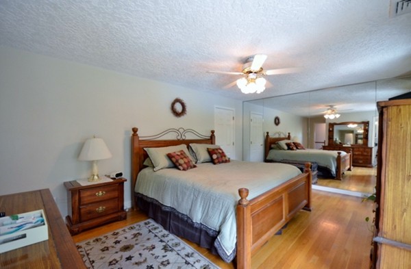 57 Green Road Bolton, MA 01740 - Photo 10 of 28 a bedroom with bed and a chandelier