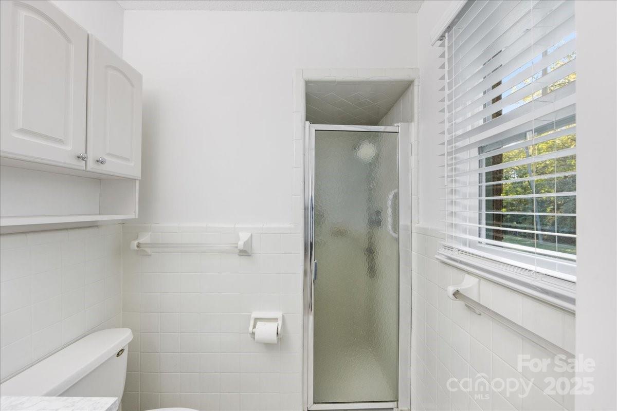 1840 Stoneyridge Drive Charlotte, NC 28214 - Photo 17 of 44 a bathroom with a toilet and a shower