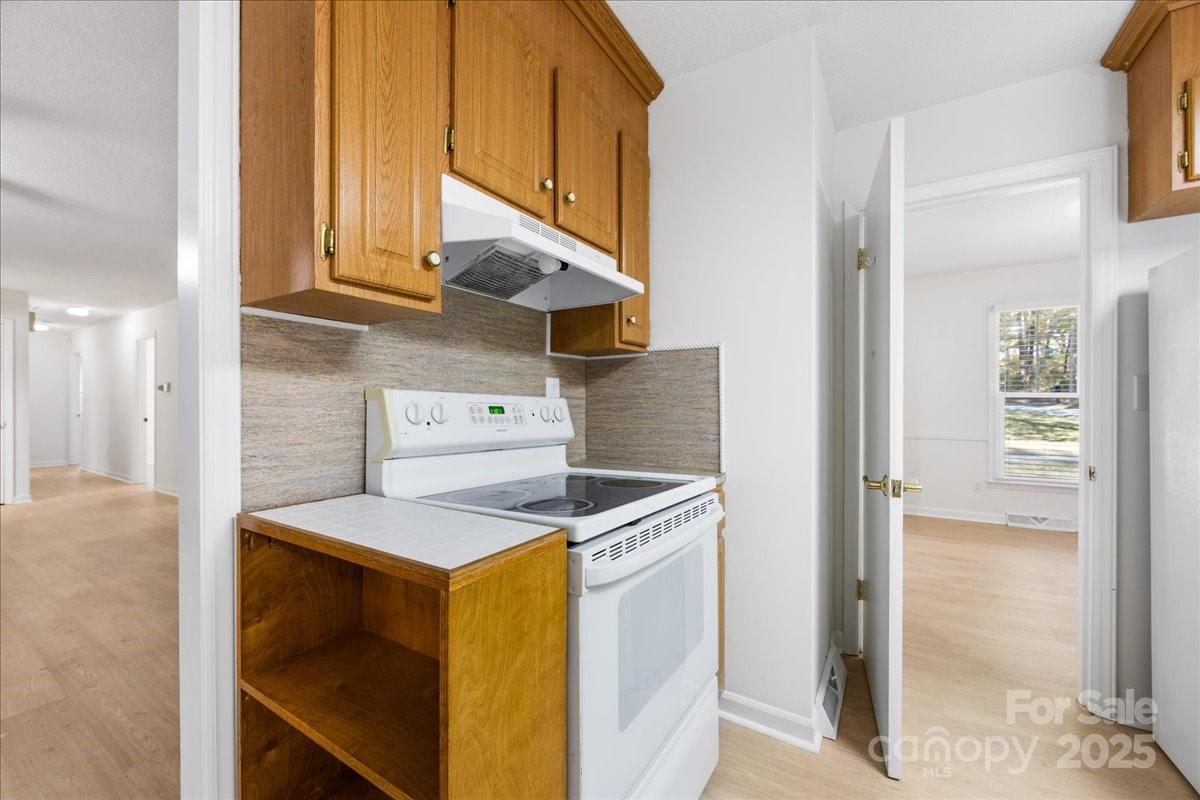 1840 Stoneyridge Drive Charlotte, NC 28214 - Photo 27 of 44 a kitchen with a stove and a microwave