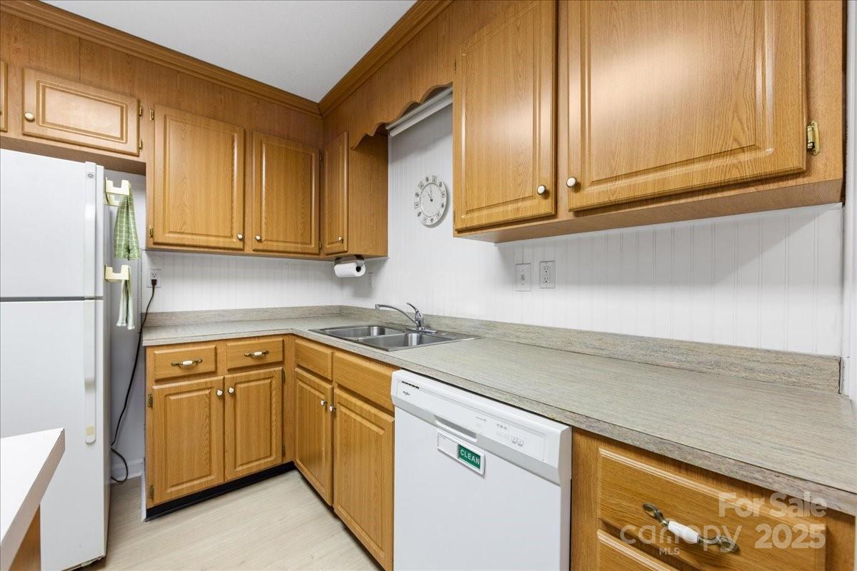 1840 Stoneyridge Drive Charlotte, NC 28214 - Photo 31 of 44 a kitchen with stainless steel appliances granite countertop a sink a stove and a refrigerator