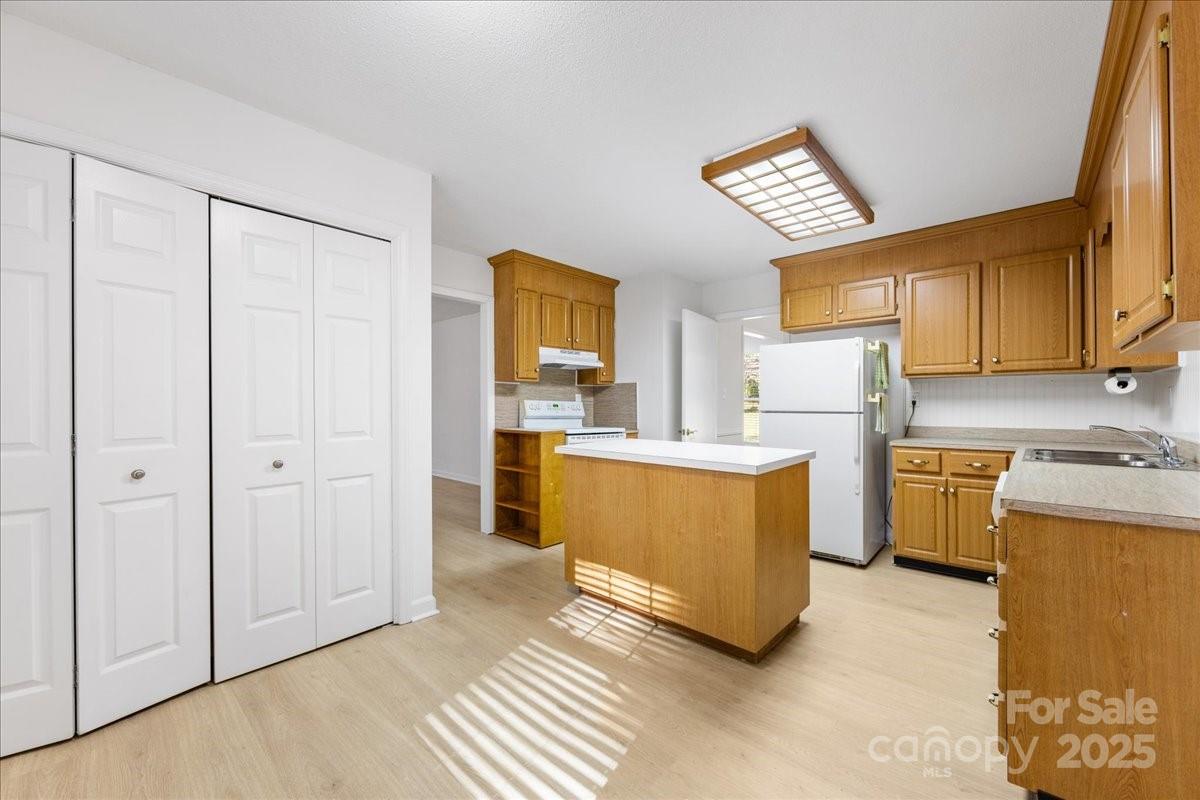 1840 Stoneyridge Drive Charlotte, NC 28214 - Photo 32 of 44 a kitchen with a refrigerator a stove a microwave a sink and cabinets