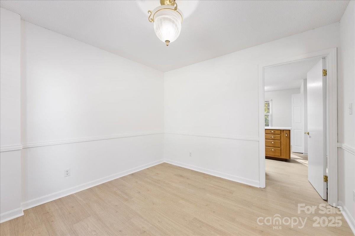 1840 Stoneyridge Drive Charlotte, NC 28214 - Photo 34 of 44 a view of a room with wooden floor and a ceiling fan