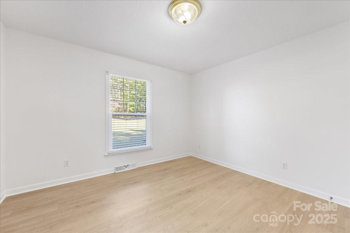 1840 Stoneyridge Drive Charlotte, NC 28214 - Photo 8 of 44 an empty room with a window